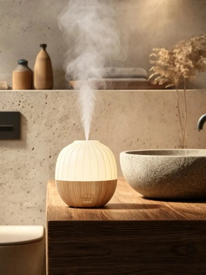 Acorn ultrasonic diffuser releasing cool mist beside a bathroom vanity