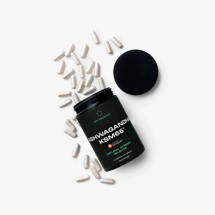 Black supplement container labeled 'KSM66' with scattered capsules on a white background